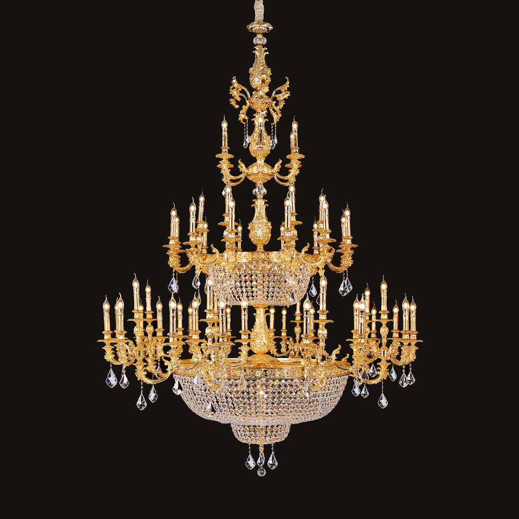 Large classic brass chandelier - lit and shown against a black background