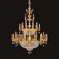 Large classic brass chandelier - lit and shown against a black background