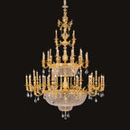 Large classic brass chandelier - lit and shown against a black background