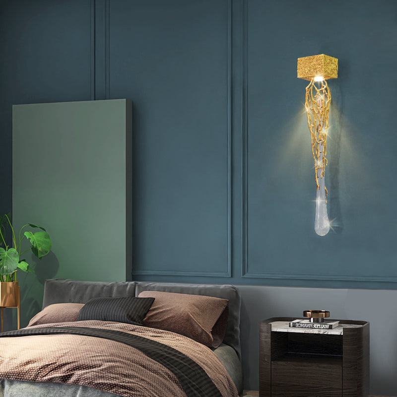 Slade branch crystal wall sconce - lit above a nightstand in a teal blue bedroom