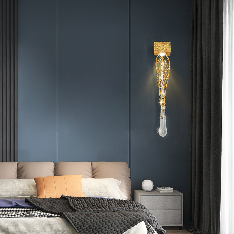 Slade branch crystal wall sconce - lit on a navy panelled wall next to floor-length curtains
