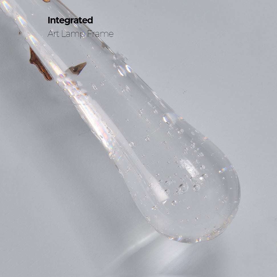 Slade branch crystal wall sconce - close-up of the clear glass teardrop with bubbles inside