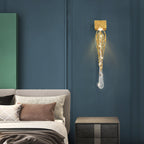 Slade branch crystal wall sconce - lit on a deep blue bedroom wall beside the bed